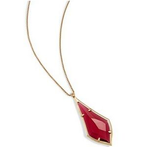 Kendra Scott gold necklace with burgundy pendant